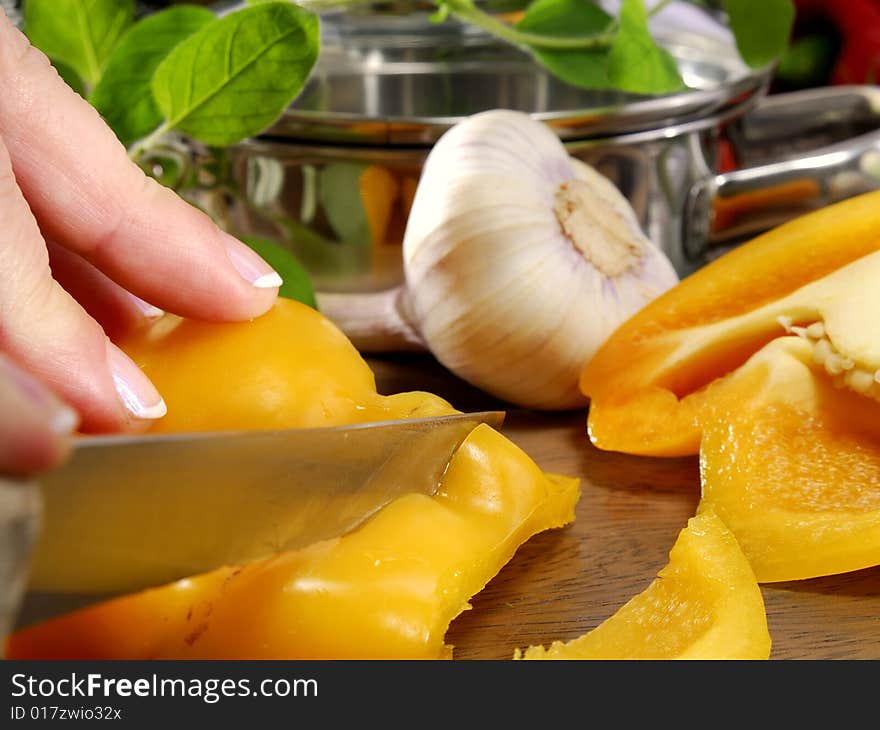 Cutting yellow pepper on a kitchen board