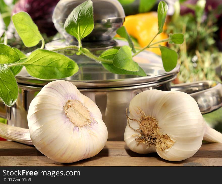 Garlic and thyme in front of a cooking pot