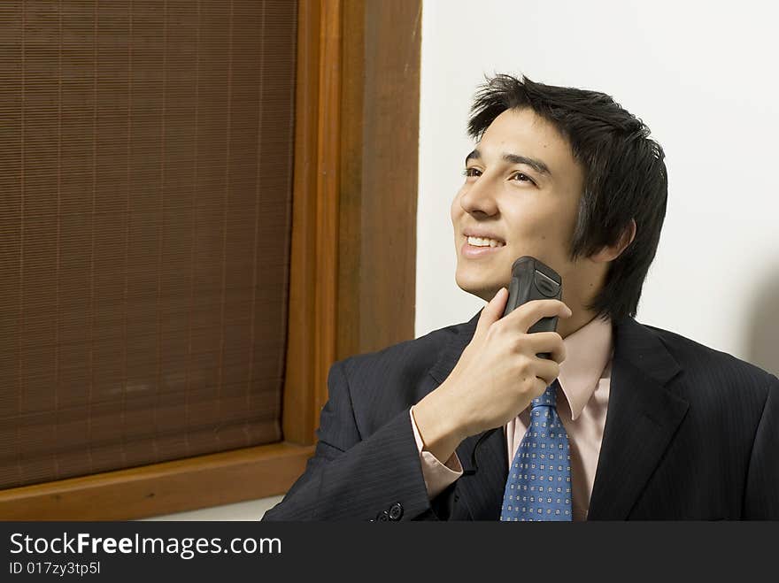 Smiling man in a suit shaving. Horizontally framed photo. Smiling man in a suit shaving. Horizontally framed photo.