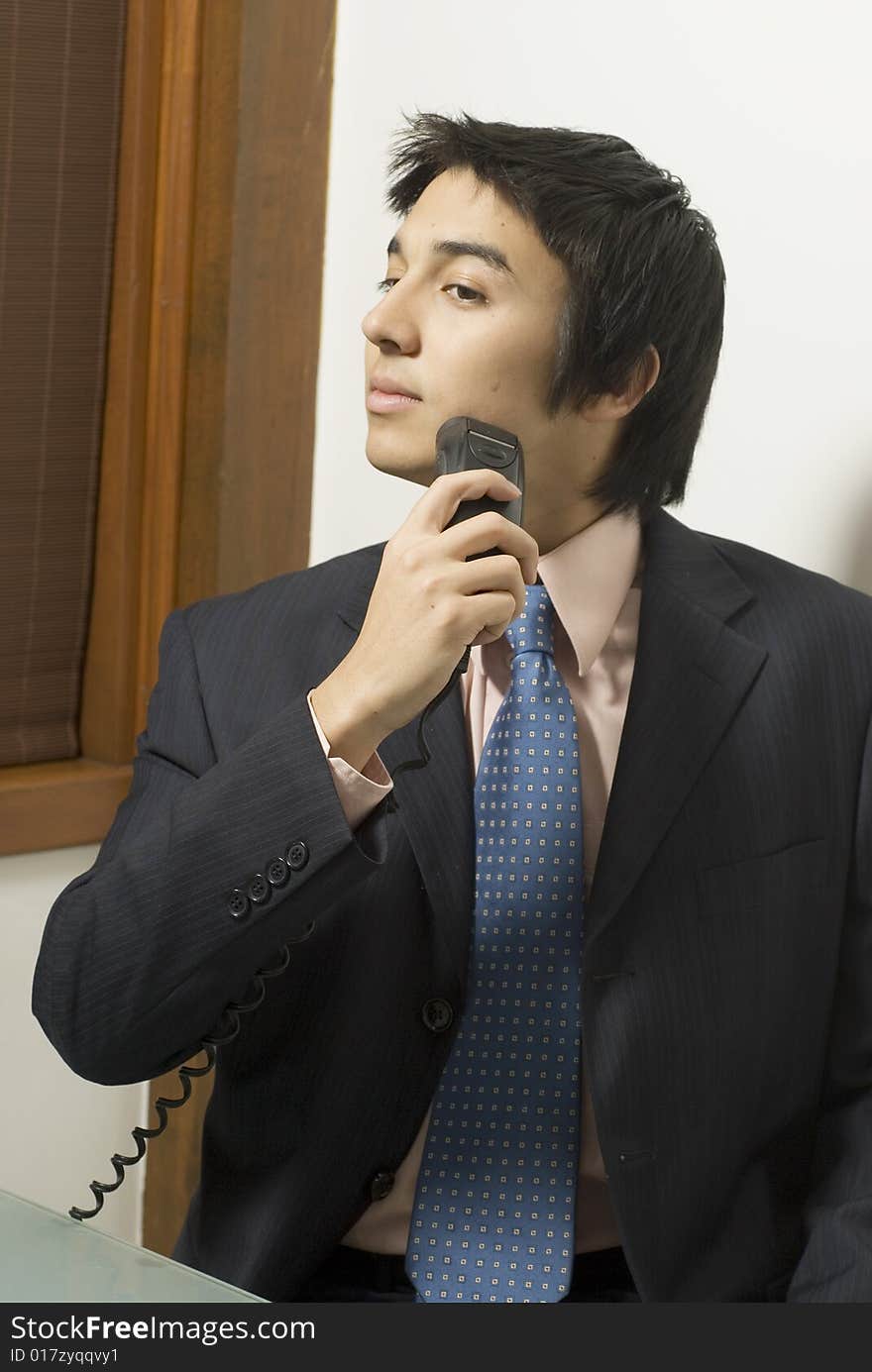 Man in a suit shaving. Vertically framed photo. Man in a suit shaving. Vertically framed photo.