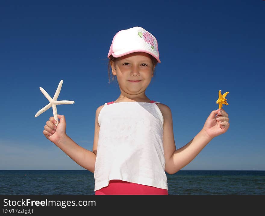 Girl with two small starfishes. Girl with two small starfishes