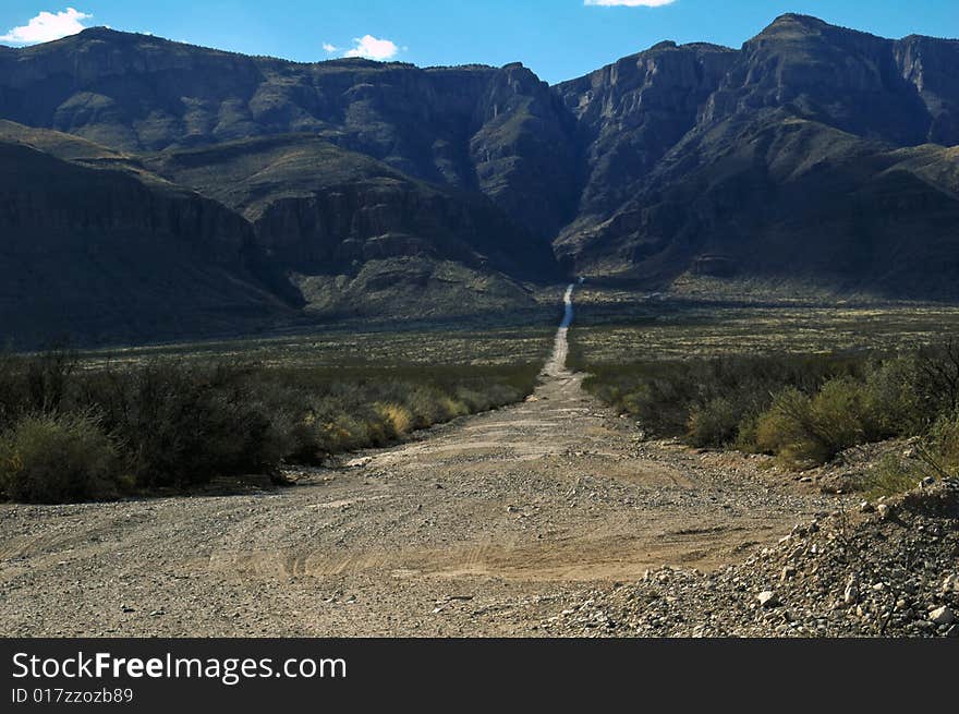 Gravel road appears to go straight into the mountain -- quite a formidable challenge awaits!. Gravel road appears to go straight into the mountain -- quite a formidable challenge awaits!