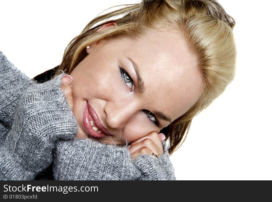 Smiling woman in a sweater isolated on white