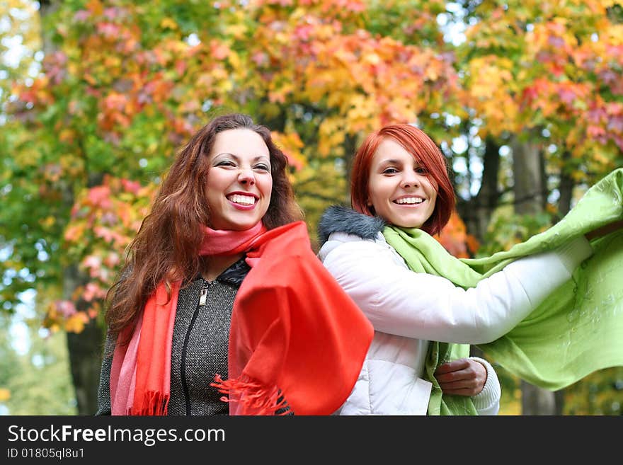 Two young girls relaxing in autumn park. Two young girls relaxing in autumn park