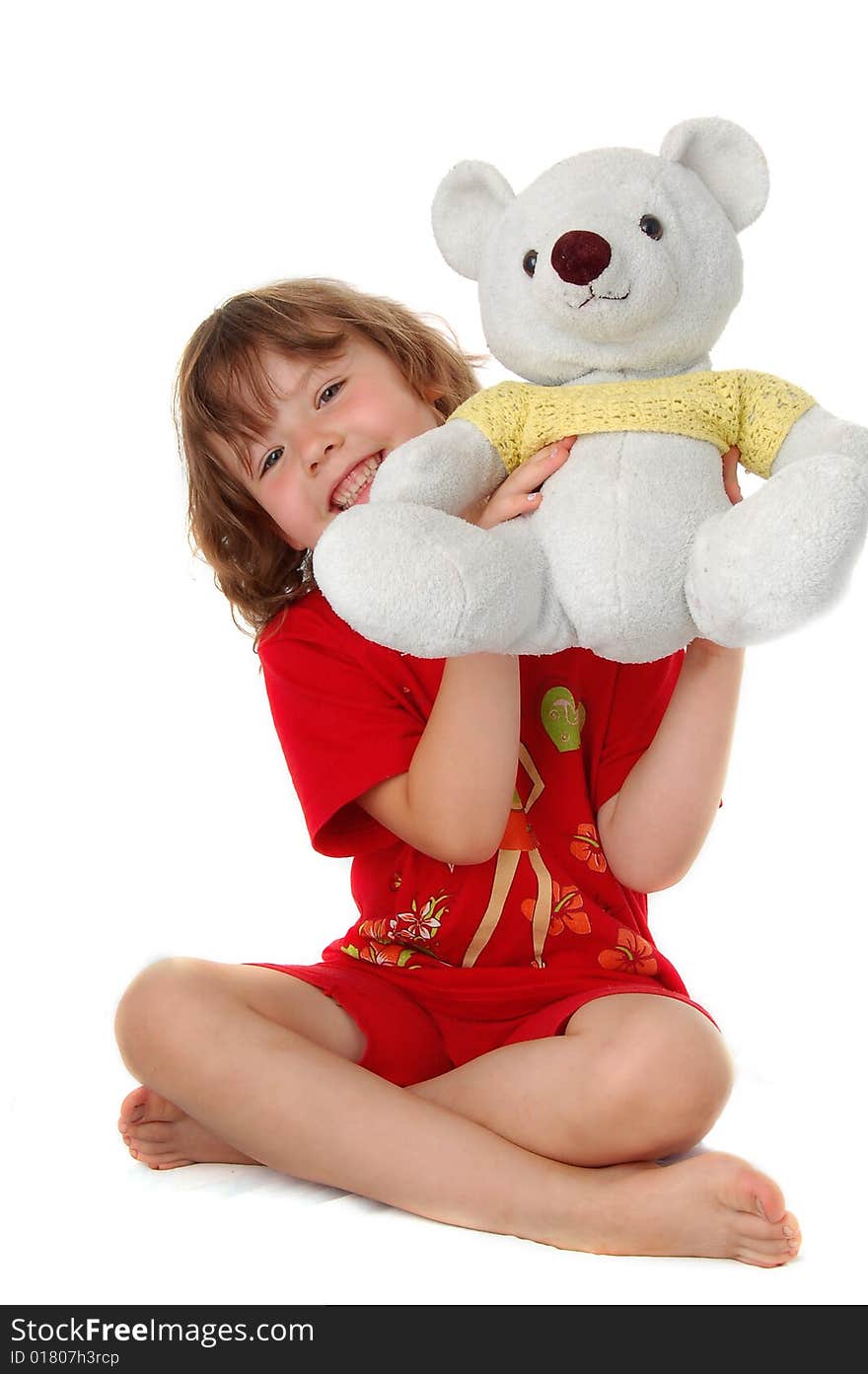 Young girl sitting on the floor with teddy bears. Isolated on white background