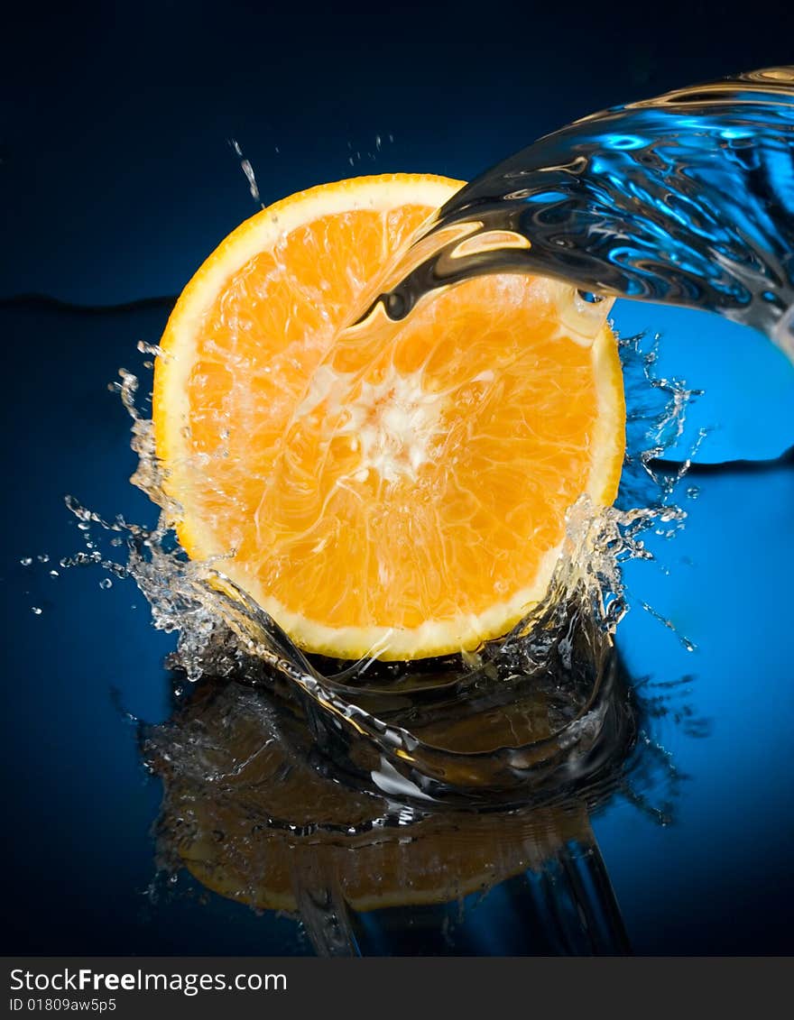 Orange with water splash, blue water. Orange with water splash, blue water