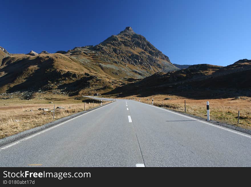 Alpen high mountains road with a car. Alpen high mountains road with a car