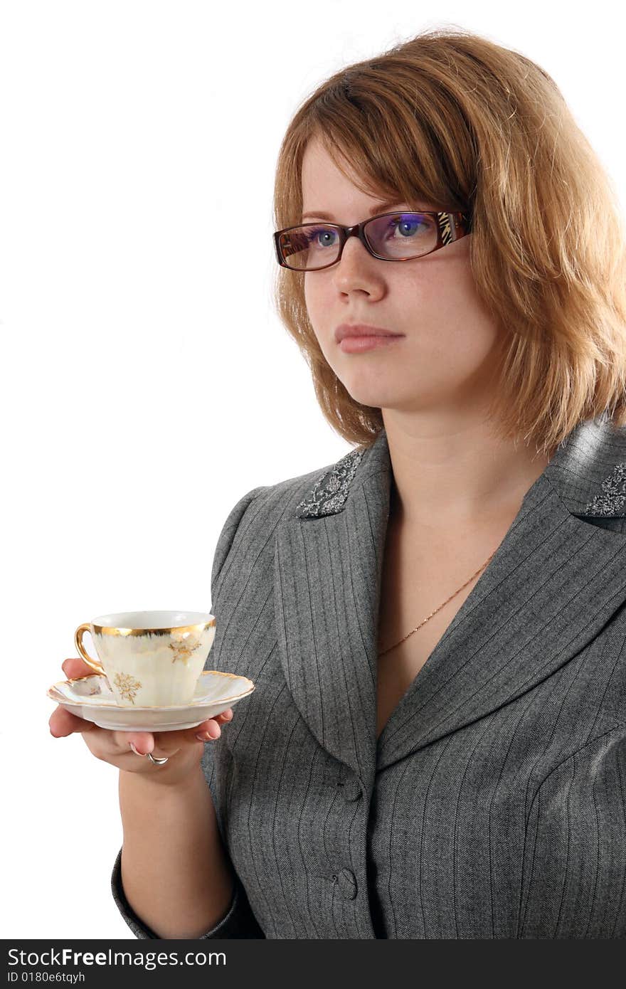 The young girl holds a coffee cup.