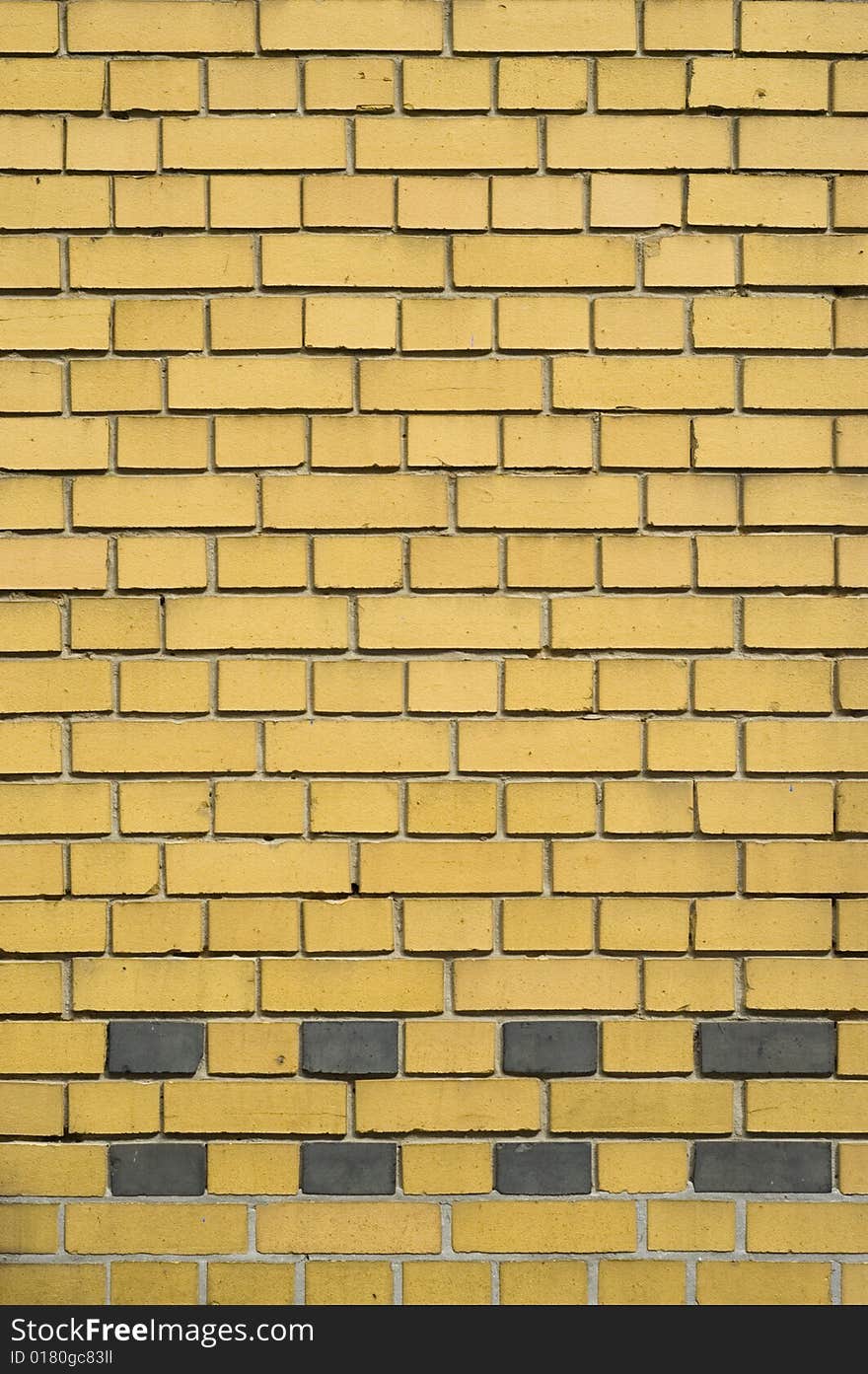 Yellow and gray brick facade, with smooth brick