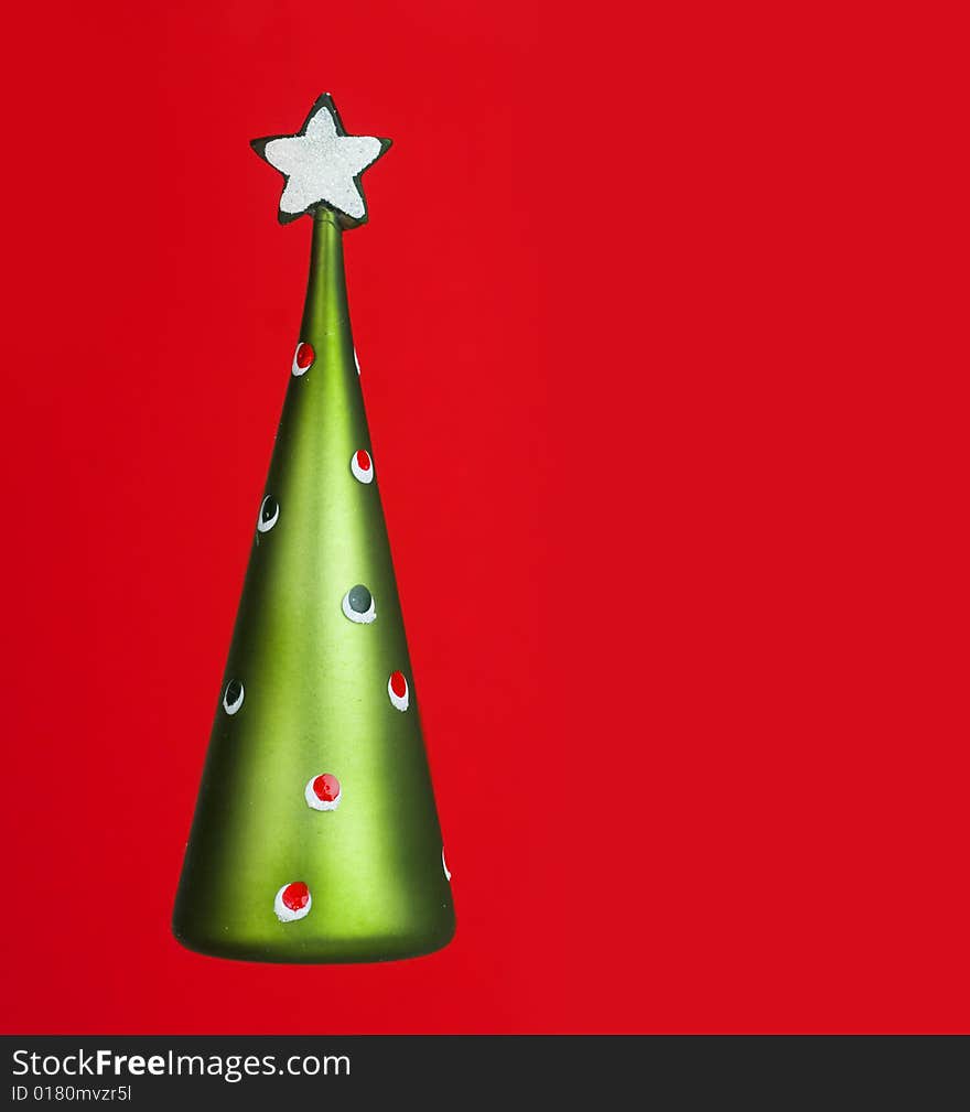 Abstract Christmas tree with star on red back ground with copy space