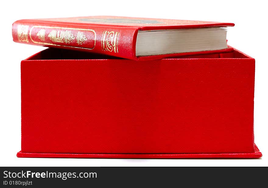 Red cover book with ornament in red cardboard box.