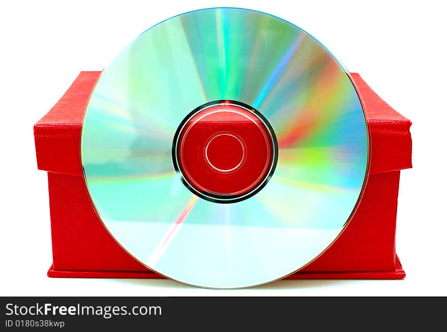 Compact-disk (CD or DVD) and red cardboard box on isolated background. Compact-disk (CD or DVD) and red cardboard box on isolated background.