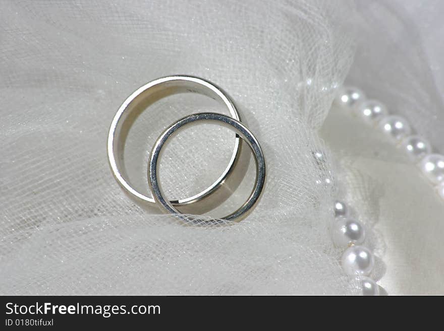 Wedding bands on a white veil. Wedding bands on a white veil