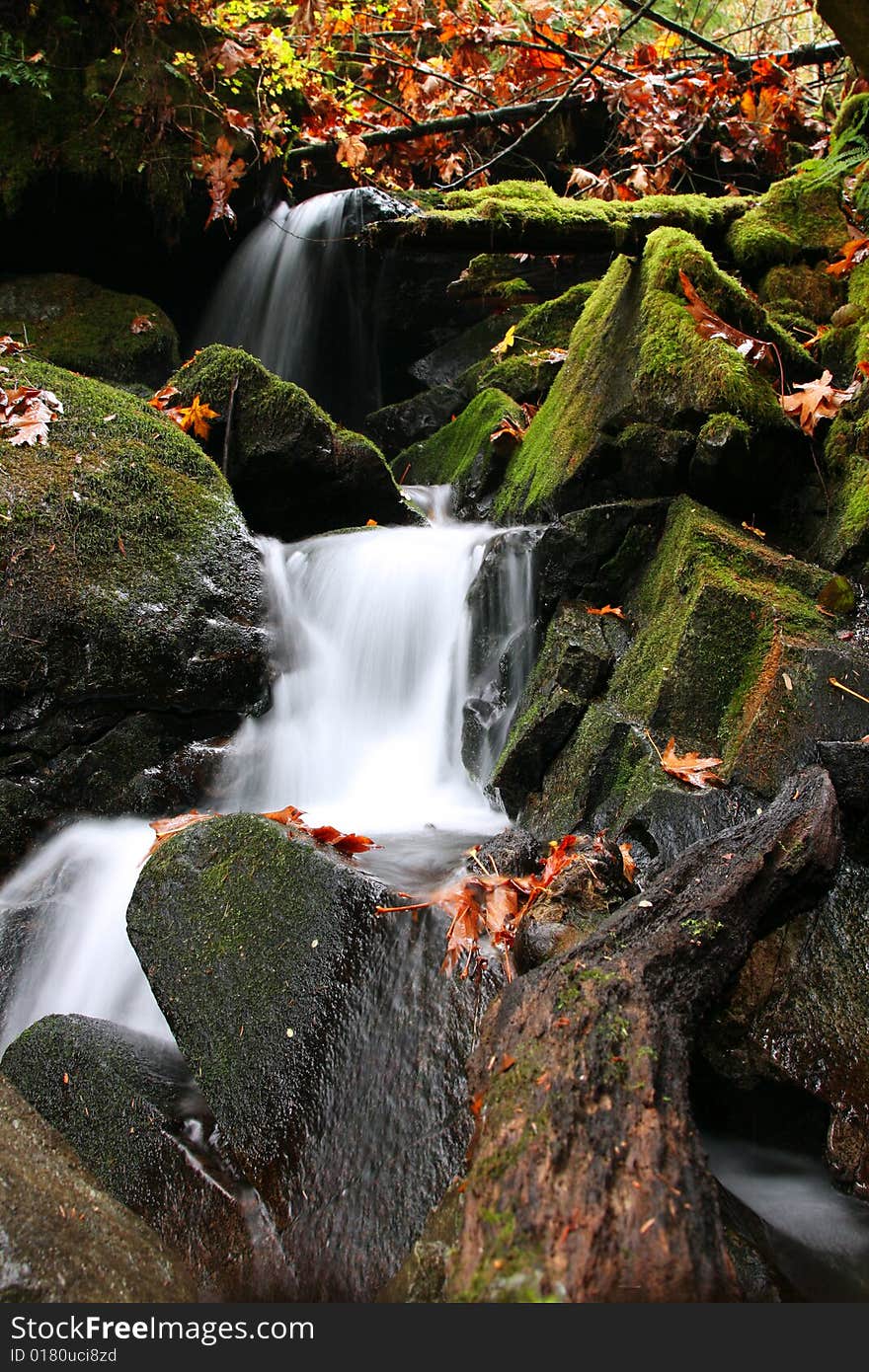 A waterwall tumbles through boulders and moss in Squamish, British Columbia. A waterwall tumbles through boulders and moss in Squamish, British Columbia