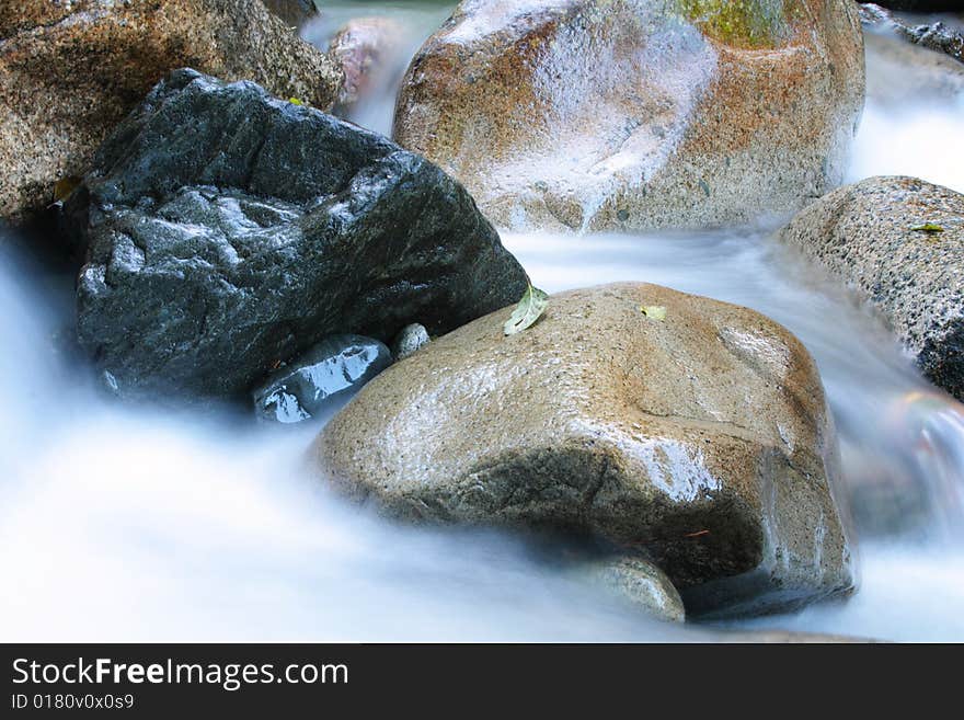 Silky water flows through damp boulders in Squamish, BC.