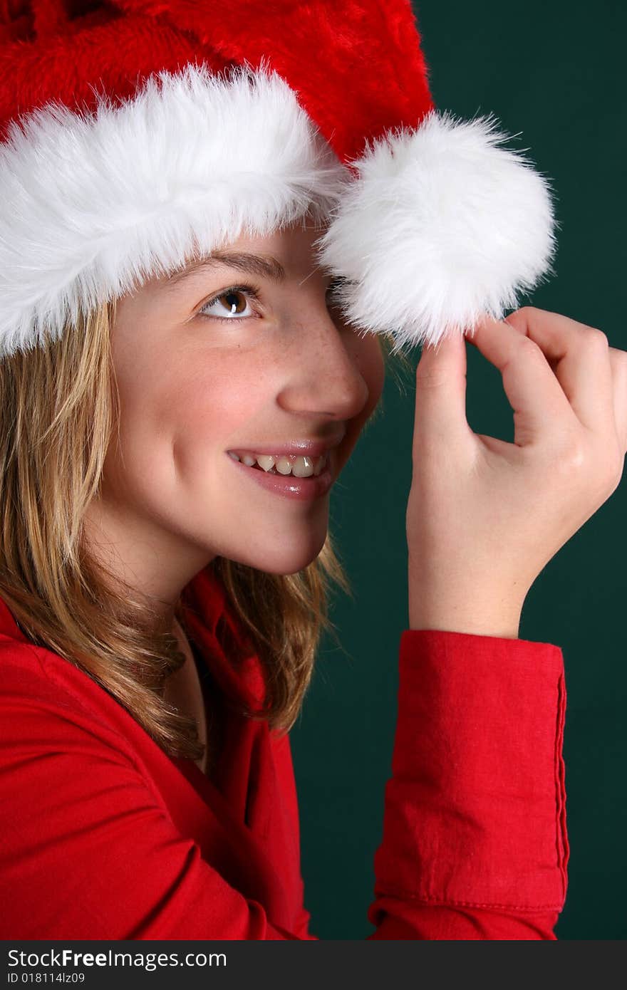 Beautiful teenager wearing a red shirt and christmas hat. Beautiful teenager wearing a red shirt and christmas hat