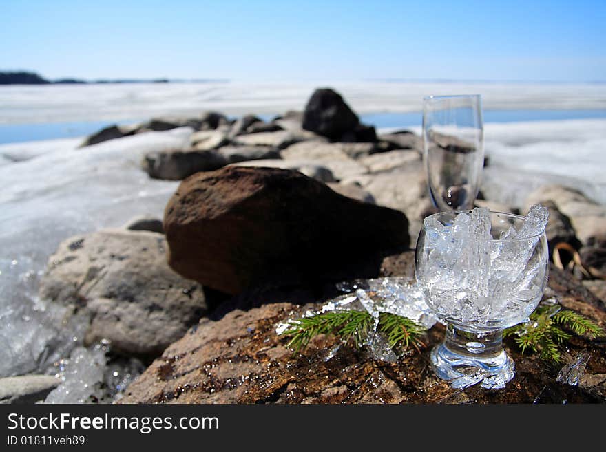 Glasses with ice on the edge of a frozen lake