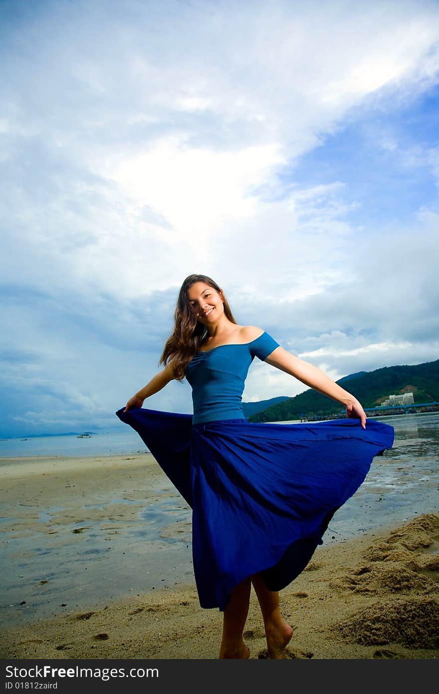 Young eurasian woman at the sunset beach