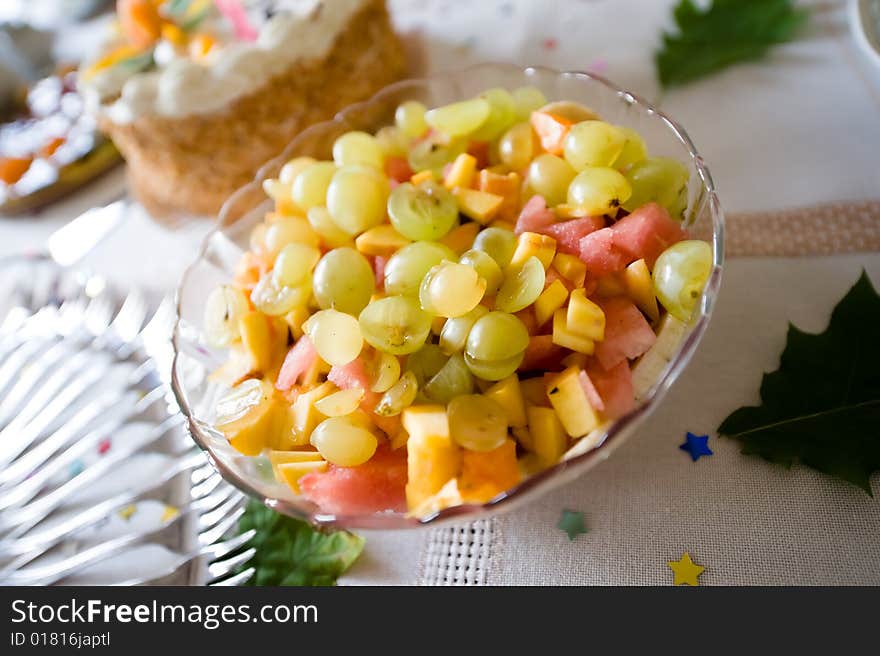 Closeup of plate of fresh fruits on birthday table. Closeup of plate of fresh fruits on birthday table