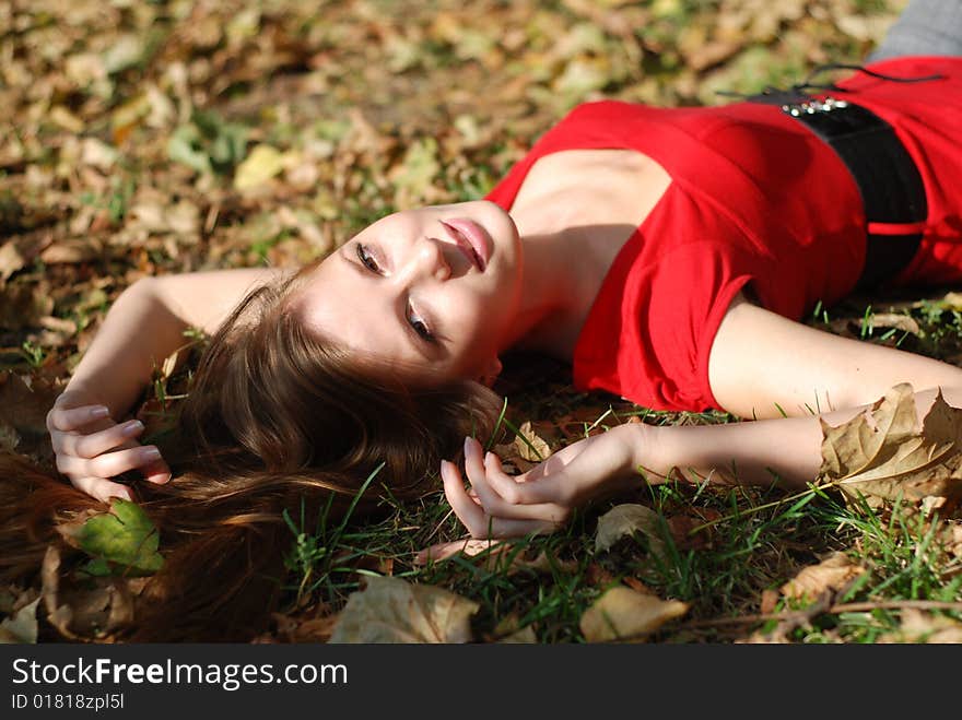 Beautiful young woman lying on the maple leaf. Beautiful young woman lying on the maple leaf