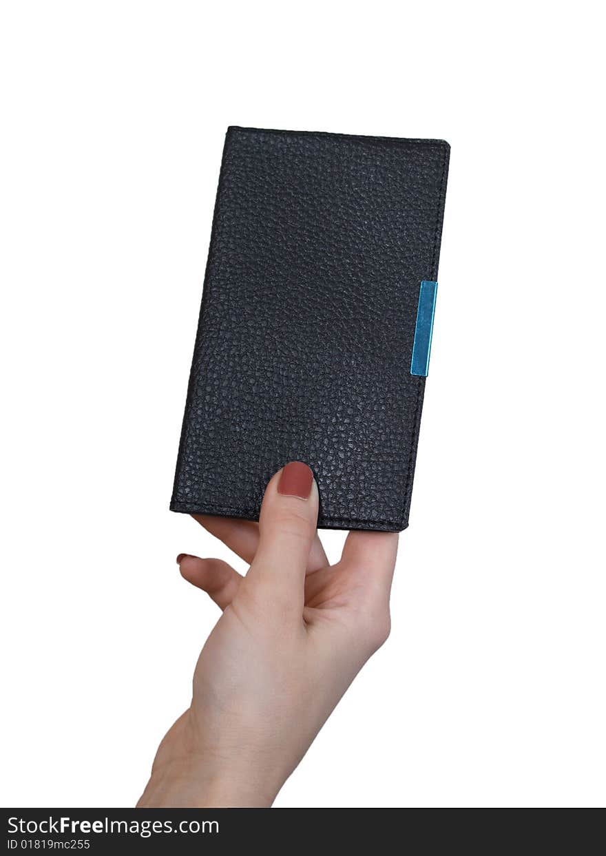 The female hand holds a small notebook on a white background. The female hand holds a small notebook on a white background