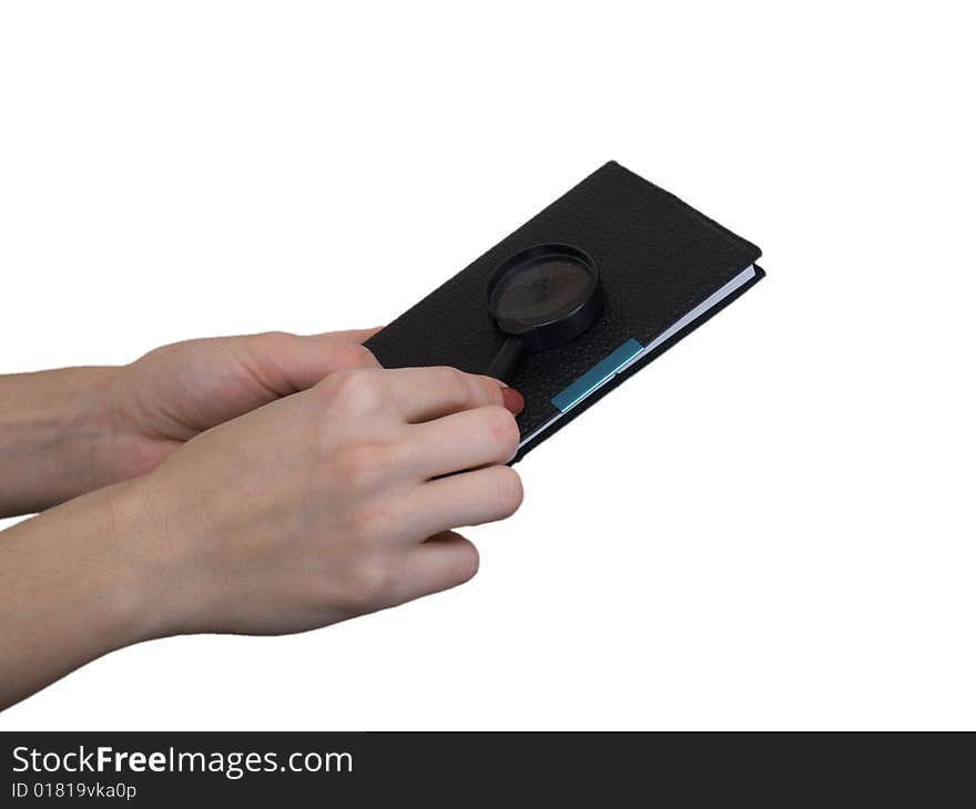 The female hand holds a small notebook on a white background. The female hand holds a small notebook on a white background