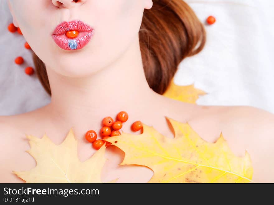 Portrait of a young woman with ashberry in her lips. Portrait of a young woman with ashberry in her lips