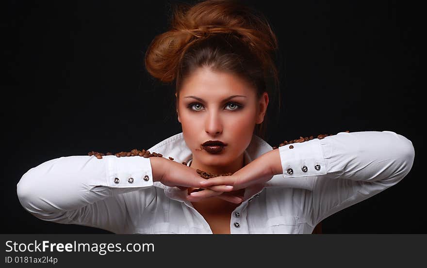 Portrait of beautiful young woman with coffee beans in her hands