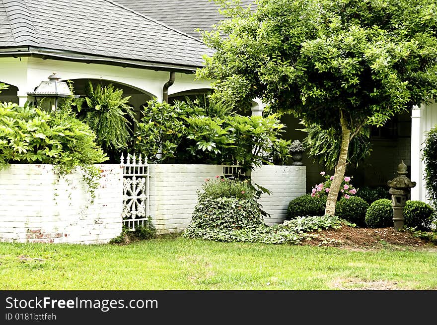 Covered porch with lush green garden and flowers. Covered porch with lush green garden and flowers