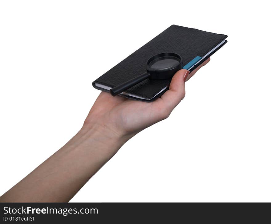 The female hand holds a small notebook on a white background. The female hand holds a small notebook on a white background