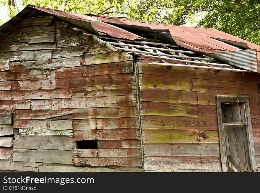 An old barn in need of repair made of wood and tin