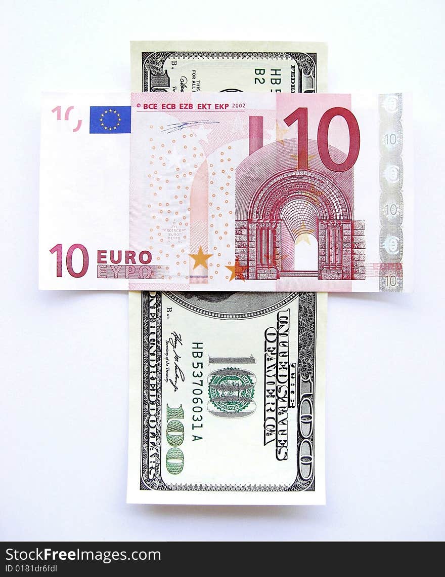 100 dollar and 10 euro in a shape of a cross. 100 dollar and 10 euro in a shape of a cross