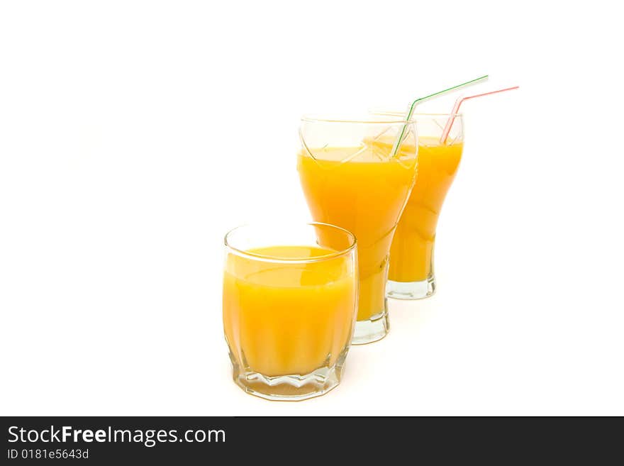 Three glasses of orange juice on white