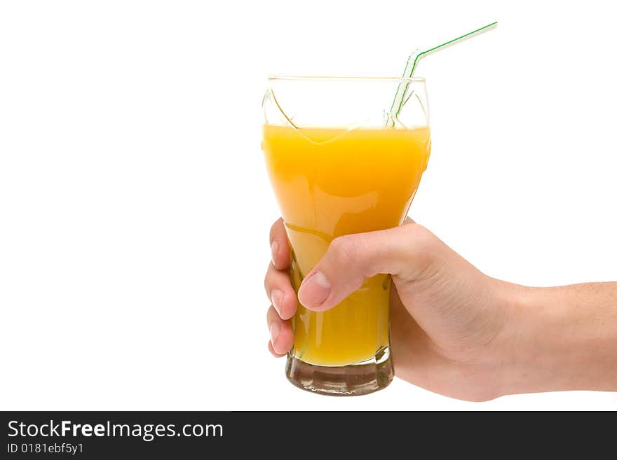 Hand holding glass of orange juice on white