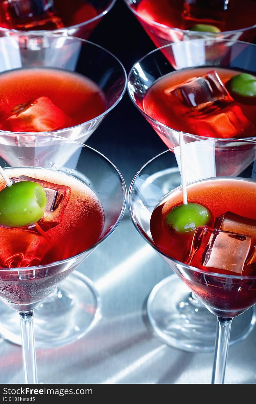 Close-up of olive on a martini glass with ice. Close-up of olive on a martini glass with ice