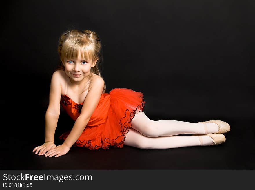 Young ballet dancer wearing a bright red tutu. Young ballet dancer wearing a bright red tutu