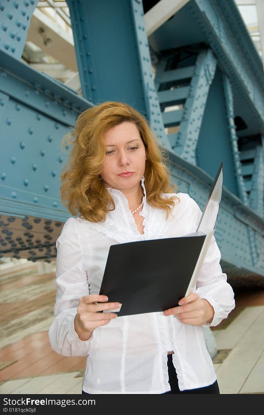 Business woman reading document in the folder