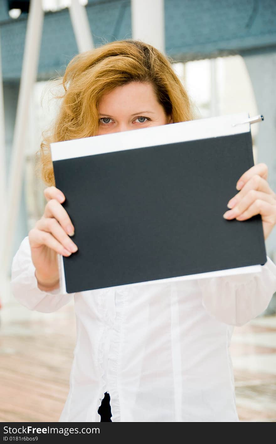 Middle age business woman hides behind the folder