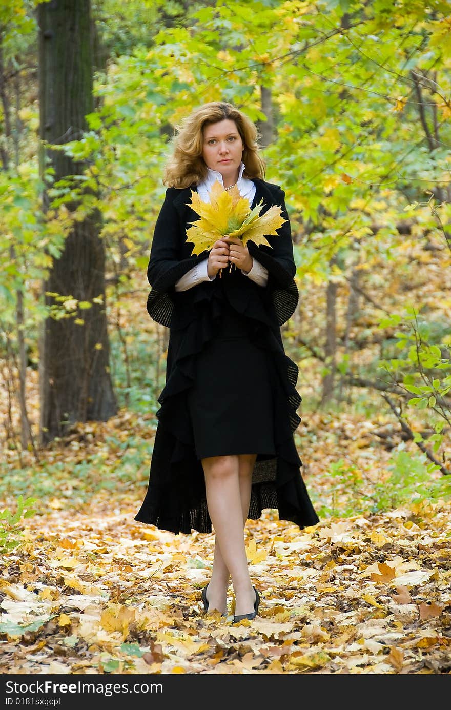 Middle age woman portrait in an autumn nature