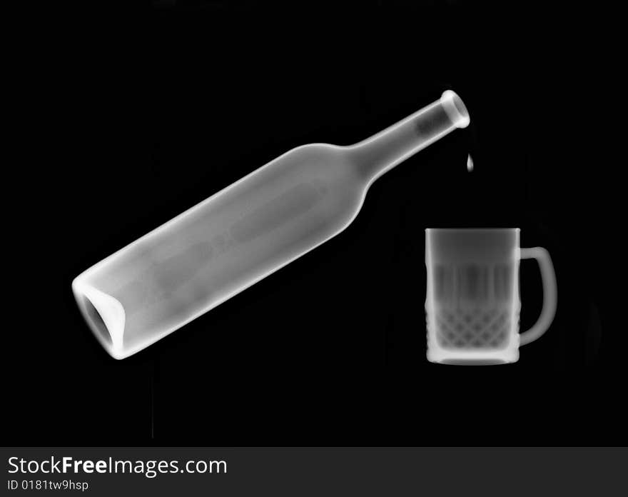 X-ray picture :drip in mug from a bottle on black background