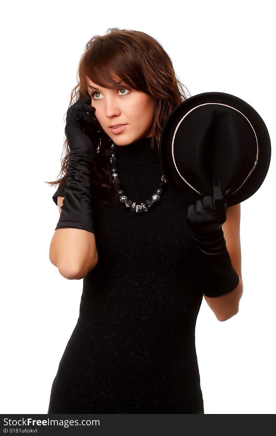 The girl in black clothes on a white background with a hat hat