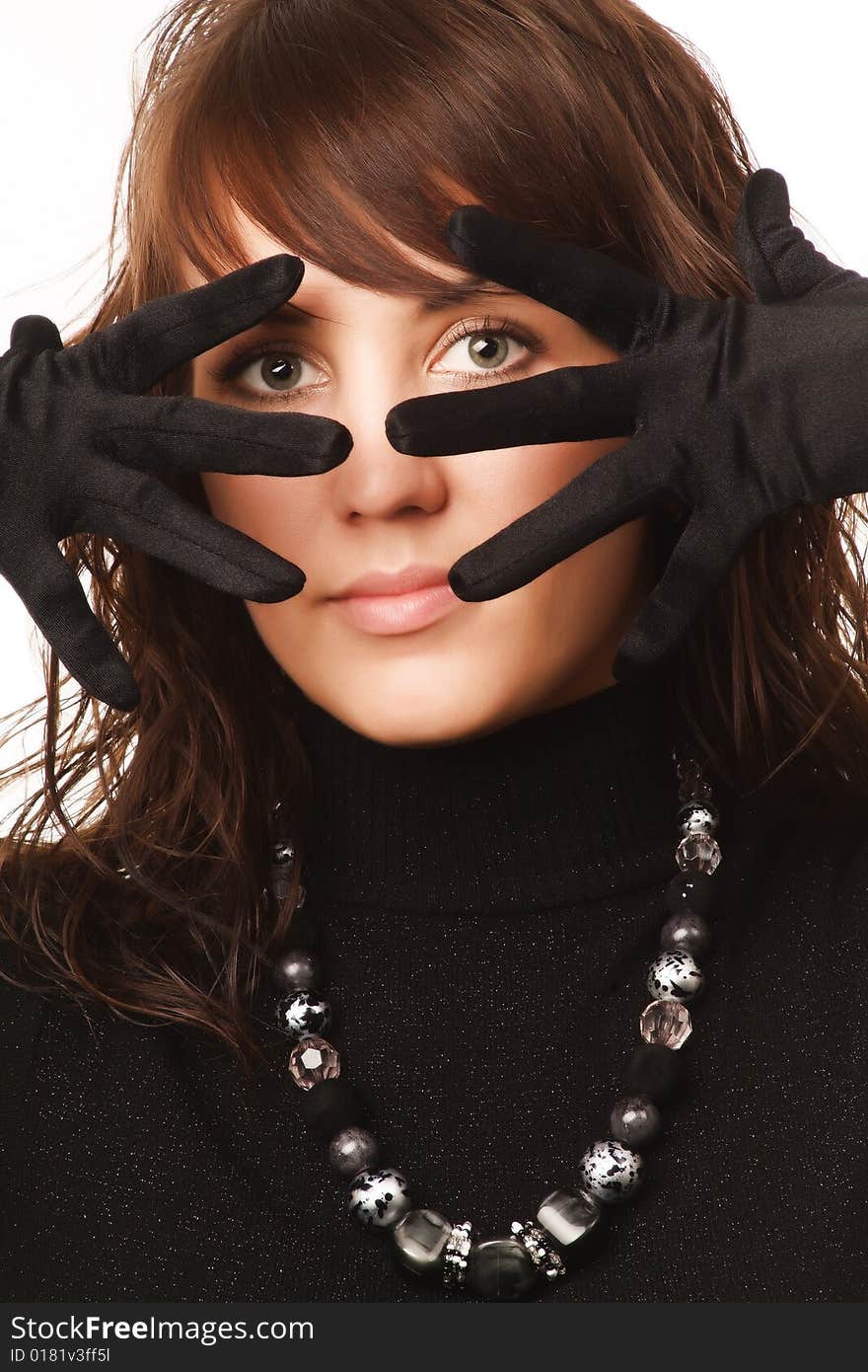 The girl in black clothes on a white background with a hat hat