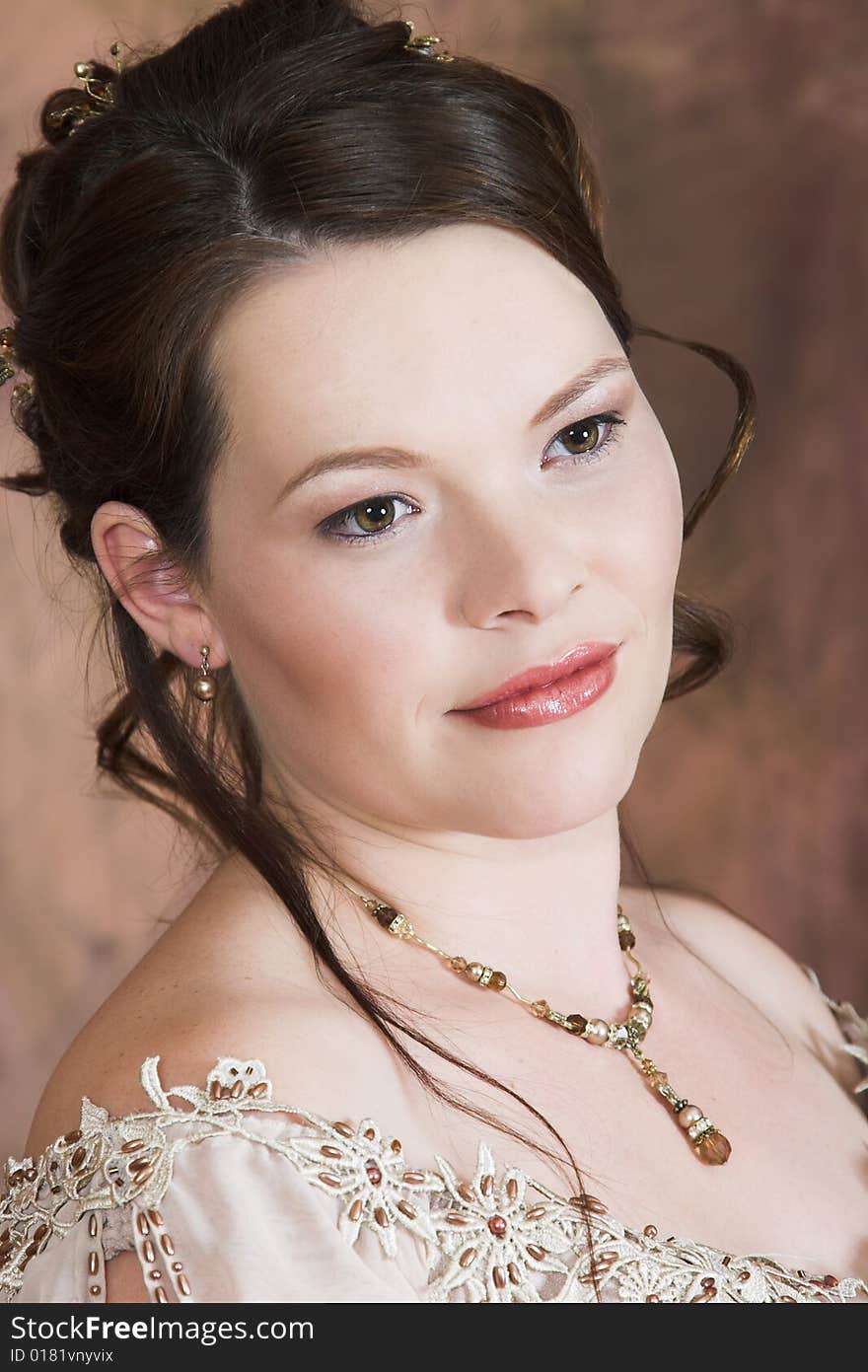 Beautiful Brunette bride in a wedding gown wearing jewelery. Beautiful Brunette bride in a wedding gown wearing jewelery