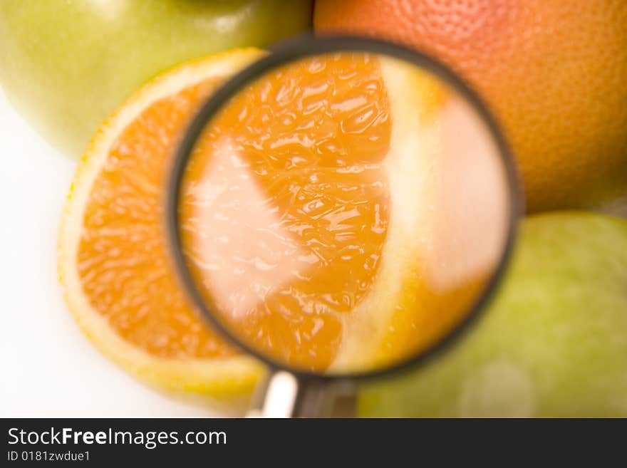 A few of citrus fruits with the orange under the lens. A few of citrus fruits with the orange under the lens