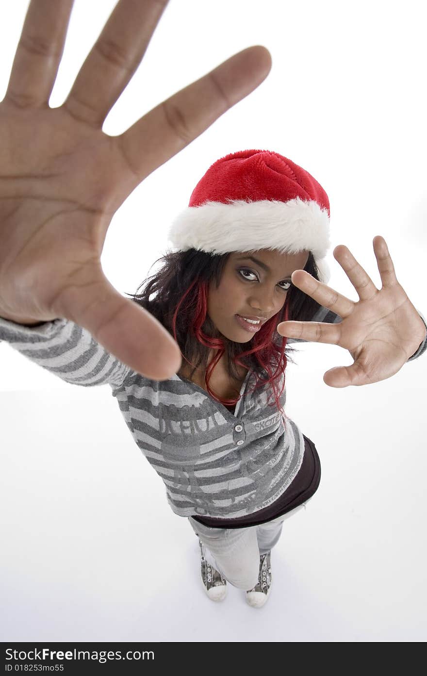 Standing african girl with christmas hat on an isolated white background