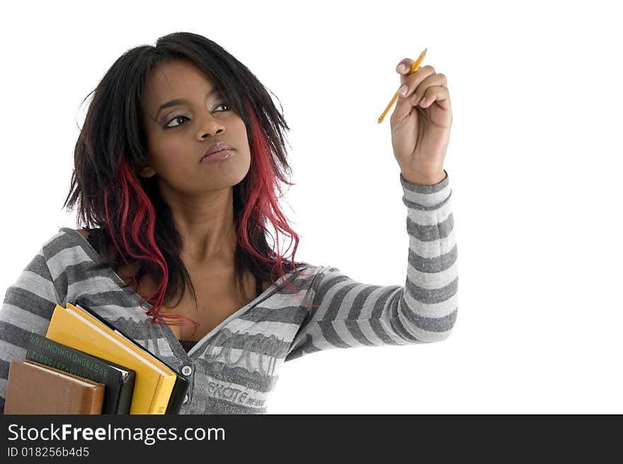 Girl with books and looking to pencil against white background