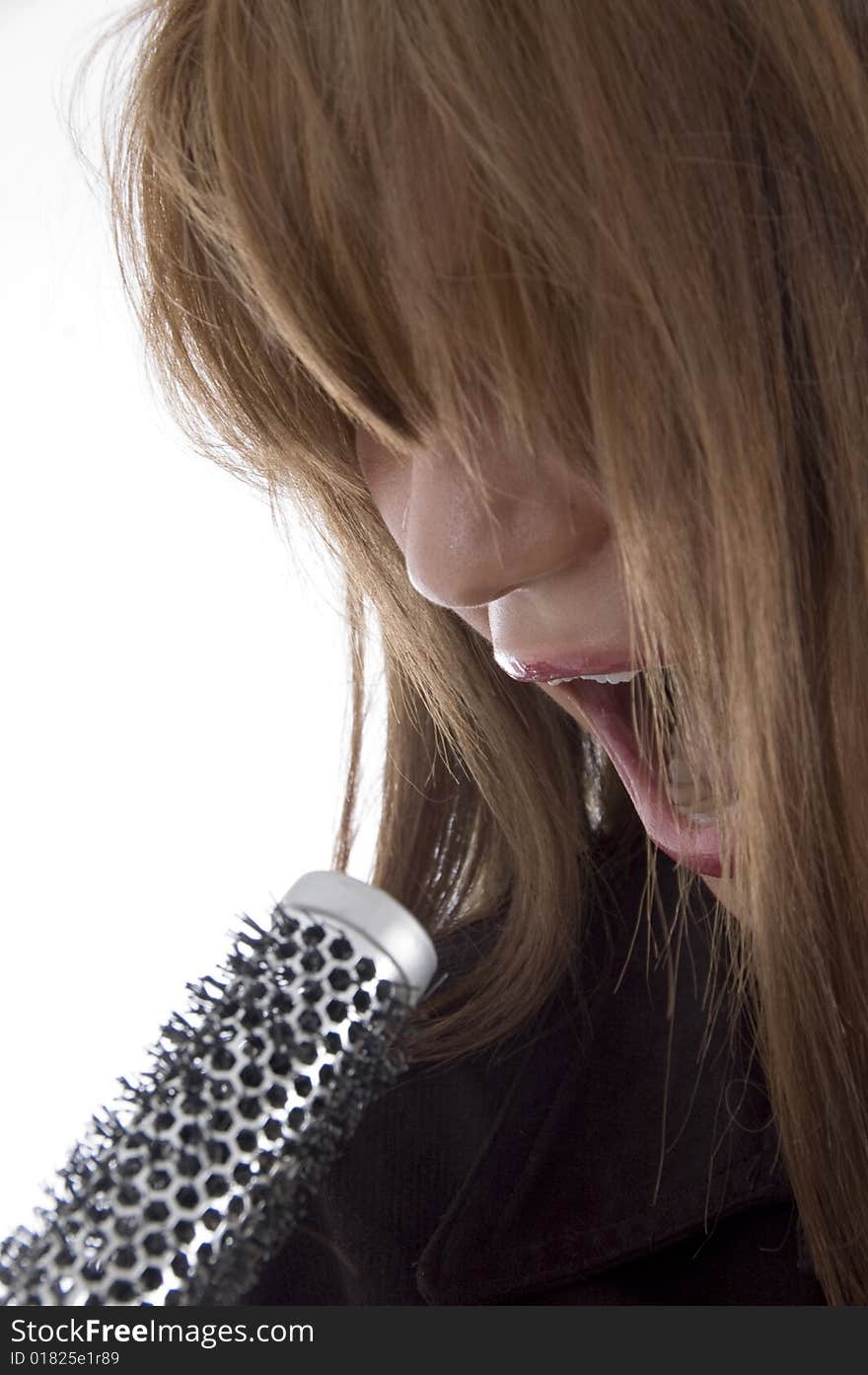 Girl singing into karaoke on an isolated background