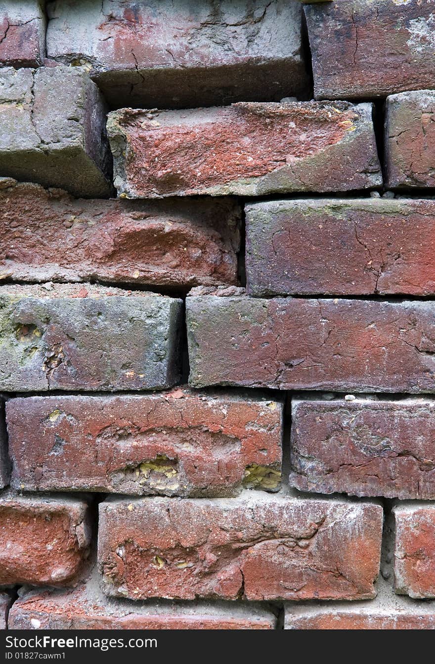 Close-up of a brick wall with eroded bricks.