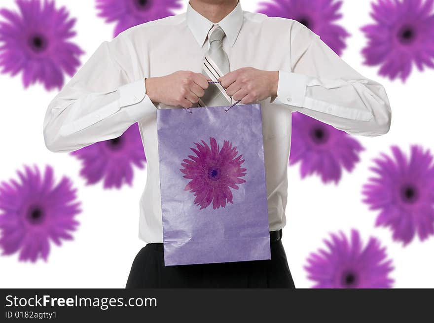 Man keeps in the palm the purple paper bag. Man keeps in the palm the purple paper bag