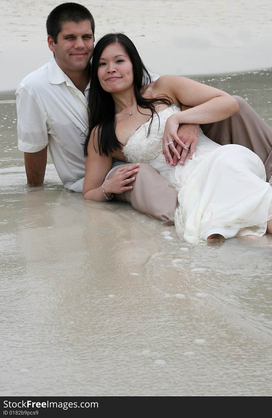 Young couple playing at the beach. Young couple playing at the beach.